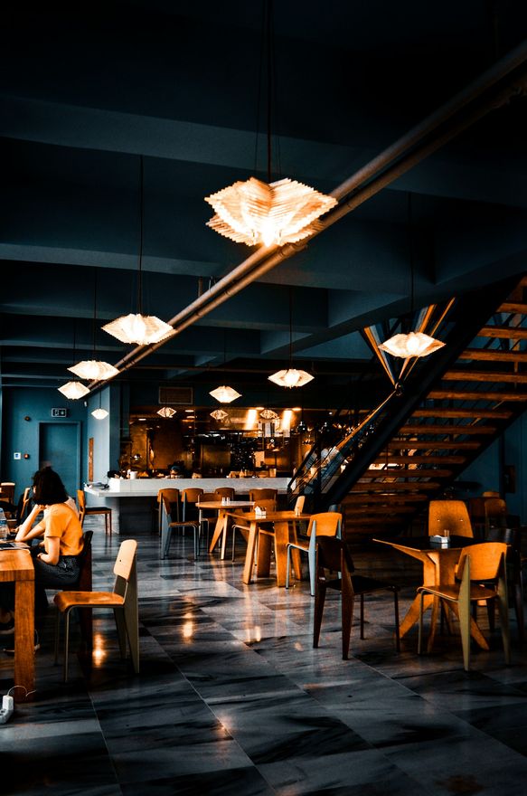 Ember's dining room before service, chairs set under low lamps