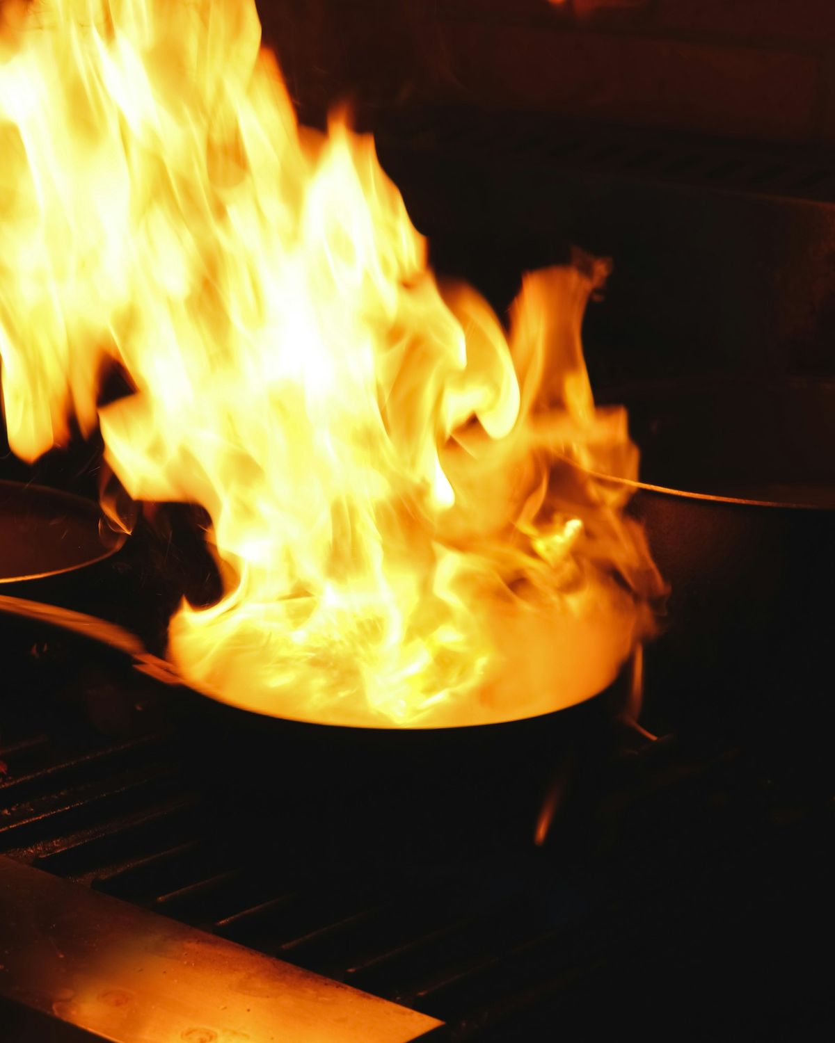 Flames rising from the wood-fired hearth in Ember's kitchen