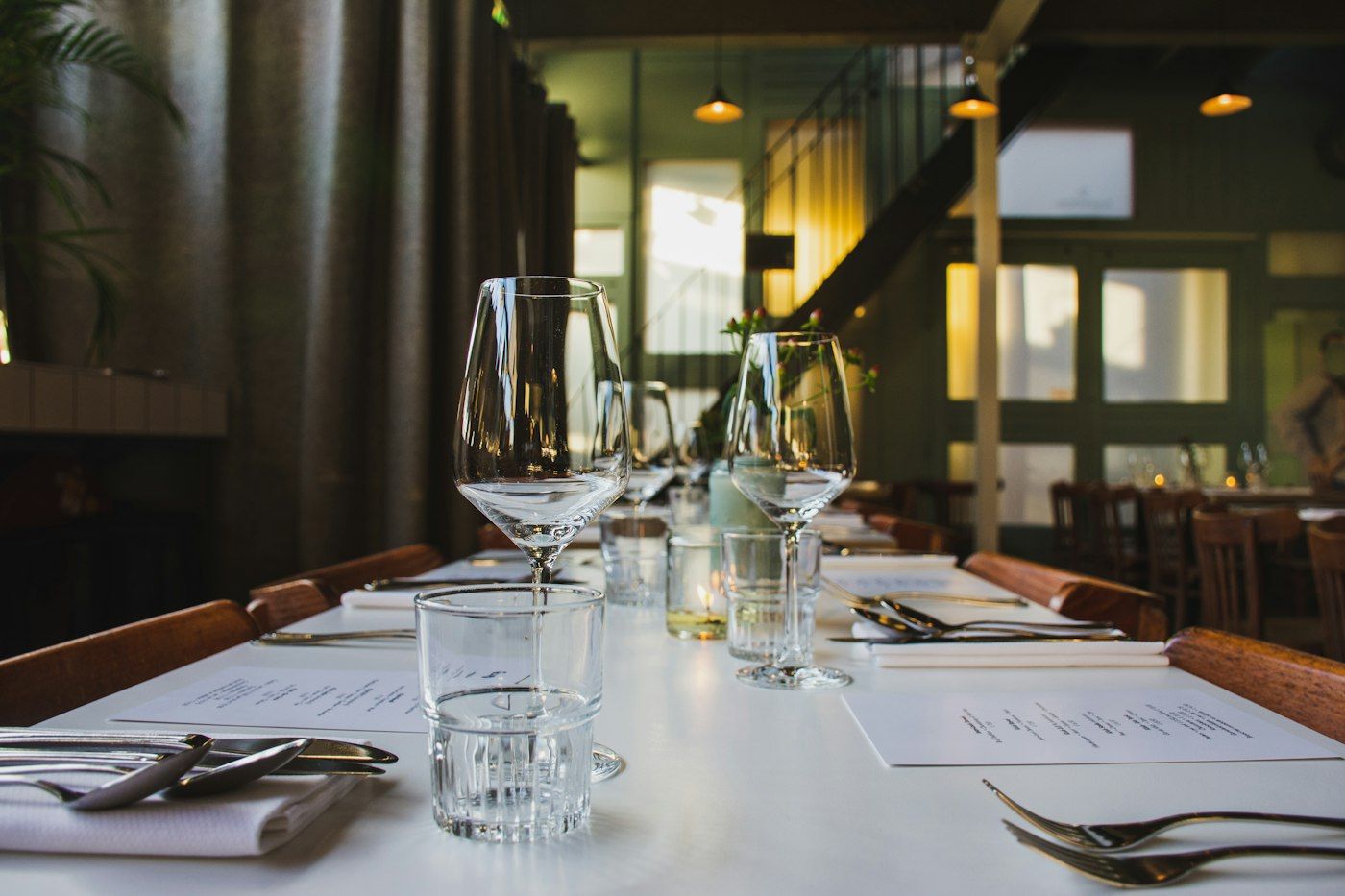 A table set with glassware under low warm light